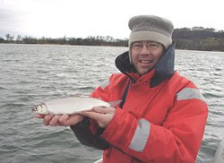 Andreas and a whitefish of the Lake of Biel. Behind You can see the island of St. Peter